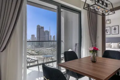 a room with a table and a view of the city at Creek Vista Elegance-1BRBurj Khalifa View in Dubai