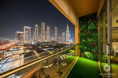 a view of a city at night from a building at Emaar Residences Fashion Avenue - 1BR - Connected to Dubai Mall - Pool with Burj View in Dubai