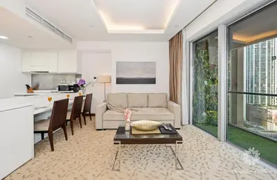 a living room with a couch and a table at Emaar Residences Fashion Avenue - 1BR - Connected to Dubai Mall - Pool with Burj View in Dubai