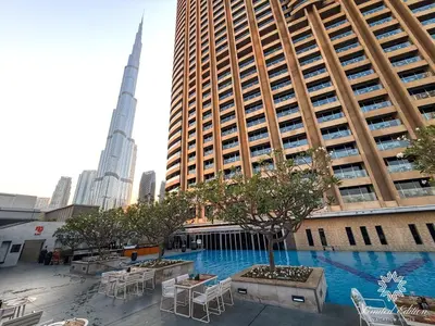 a large swimming pool in a city with tall buildings at Emaar Residences Fashion Avenue - 1BR - Connected to Dubai Mall - Pool with Burj View in Dubai