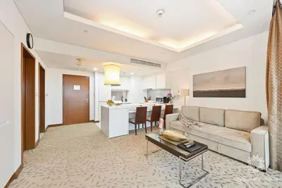 a living room with a couch and a table at Emaar Residences Fashion Avenue - 1BR - Connected to Dubai Mall - Pool with Burj View in Dubai