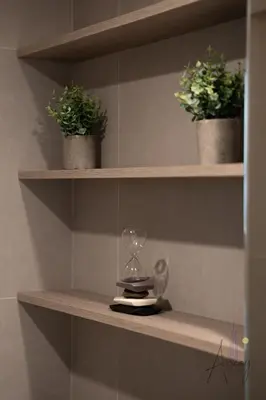 a shelf with a wine glass and two potted plants at Luxe Desiged Stu Dubai Marina Dream LIV Marina in Dubai