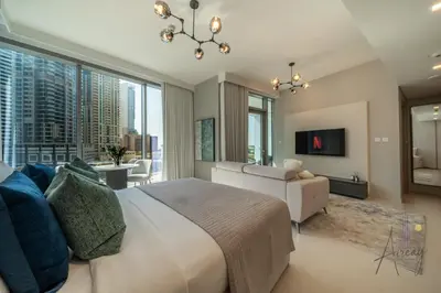 a bedroom with a large bed and a couch at Luxe Desiged Stu Dubai Marina Dream LIV Marina in Dubai