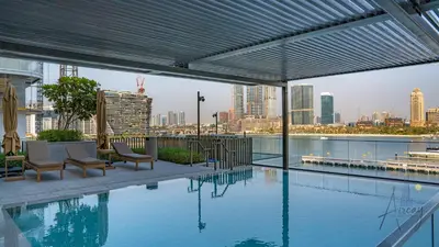 a swimming pool with a view of a city skyline at Elite Beachfront Living Stylish High-Floor 1BR in Dubai