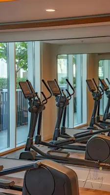 a row of treadmills in a gym reflected in a mirror at Elite Beachfront Living Stylish High-Floor 1BR in Dubai