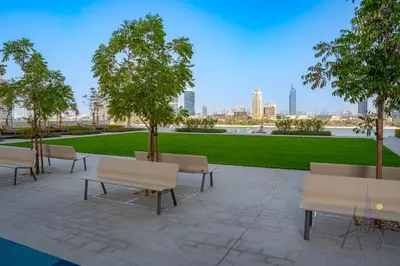 a group of benches and trees in a park at Elite Beachfront Living Stylish High-Floor 1BR in Dubai