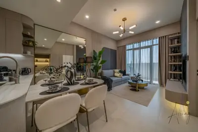 a kitchen and living room with a table and chairs at Cosy Corner 1BR Designer Apt Luxe Nest in JVC in Dubai