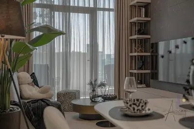 a living room with a teddy bear sitting in a chair at Cosy Corner 1BR Designer Apt Luxe Nest in JVC in Dubai