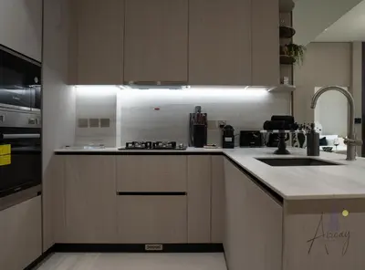 a kitchen with a sink and a counter top at Cosy Corner 1BR Designer Apt Luxe Nest in JVC in Dubai
