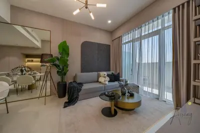a living room with a couch and a table at Cosy Corner 1BR Designer Apt Luxe Nest in JVC in Dubai