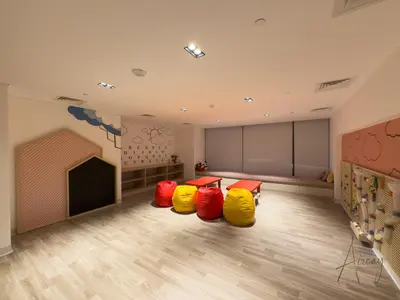 a room with four yellow and red bouncy chairs in it at Burj Khalifa View Luxe 1BR Paragon by IGO in Dubai