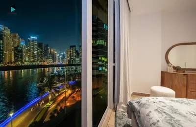 a bedroom with a view of a city at night at Modern Marina-View 3 BR Prime Waterfront in Dubai