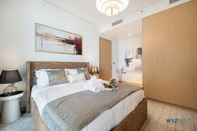 a bedroom with a large bed with towels on it at Ritz 1BR Vida Dubai Mall Hotel Amenity & Mall Access in Dubai