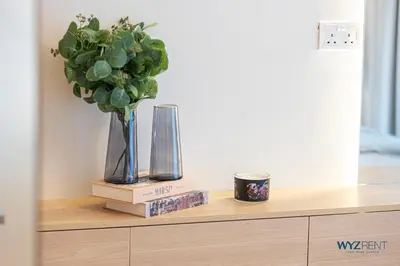 a shelf with two vases and a plant on it at Ritz 1BR Vida Dubai Mall Hotel Amenity & Mall Access in Dubai