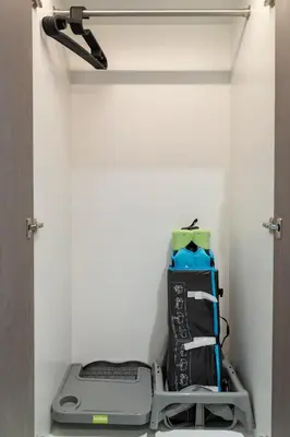 a treadmill and other items in a closet at Cozy 1BR at D1 Residence 13 with Stunning City View in Dubai
