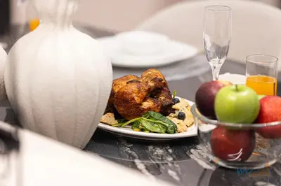 a plate of food on a table with fruits and vegetables at Posh 2BR Vida Dubai Mall Hotel Amenity & Mall Access in Dubai