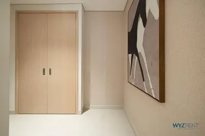 a hallway with a door and a painting on the wall at Posh 2BR Vida Dubai Mall Hotel Amenity & Mall Access in Dubai