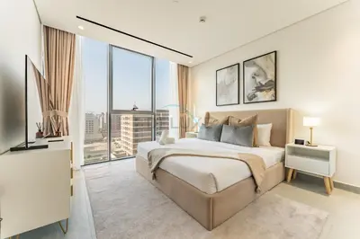 a bedroom with a large bed and large windows at Minutes from City Walk, Downtown Dubai and Jumeirah Beach, Easy Access to Metro Stations and Major Roads - Arista One, Al Satwa by Deluxe Holiday Homes in Dubai