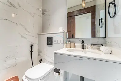 a white bathroom with a sink and a toilet at Minutes from City Walk, Downtown Dubai and Jumeirah Beach, Easy Access to Metro Stations and Major Roads - Arista One, Al Satwa by Deluxe Holiday Homes in Dubai