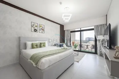 a white bedroom with a large bed and a window at Prime Location, Near Bus Stop, Steps from the Park, Just 20 Minutes to Dubai Marina - Oxford Boulevard, Jumeirah Village Circle by Deluxe Holiday Homes in Dubai