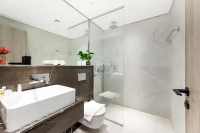 a bathroom with a sink and a toilet and a shower at Prime Location, Near Bus Stop, Steps from the Park, Just 20 Minutes to Dubai Marina - Oxford Boulevard, Jumeirah Village Circle by Deluxe Holiday Homes in Dubai