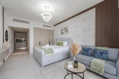 a living room with a bed and a couch at Prime Location, Near Bus Stop, Steps from the Park, Just 20 Minutes to Dubai Marina - Oxford Boulevard, Jumeirah Village Circle by Deluxe Holiday Homes in Dubai