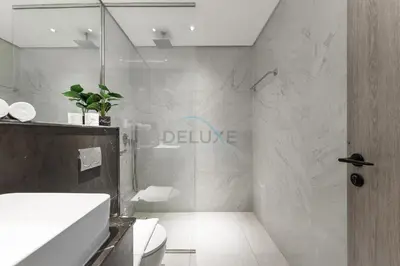 a bathroom with a shower and a sink and a toilet at Prime Location, Near Bus Stop, Steps from the Park, Just 20 Minutes to Dubai Marina - Oxford Boulevard, Jumeirah Village Circle by Deluxe Holiday Homes in Dubai