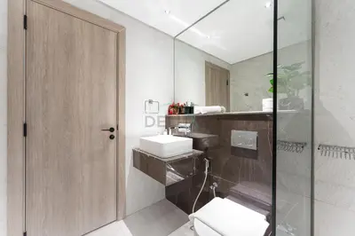 a bathroom with a sink and a glass shower at Prime Location, Near Bus Stop, Steps from the Park, Just 20 Minutes to Dubai Marina - Oxford Boulevard, Jumeirah Village Circle by Deluxe Holiday Homes in Dubai