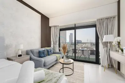 a living room with a bed and a couch at Prime Location, Near Bus Stop, Steps from the Park, Just 20 Minutes to Dubai Marina - Oxford Boulevard, Jumeirah Village Circle by Deluxe Holiday Homes in Dubai