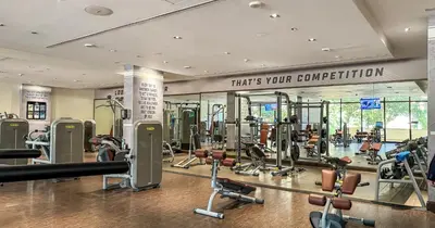 a gym with a lot of treadmills and machines at 1BR Apartment Anantara Palm Private Beach in Dubai