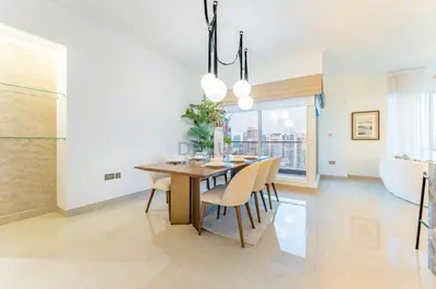 a dining room with a wooden table and chairs at Full Yacht Harbour and Marina Canal Views, Walking Distance to Tram Station and Beach - Shemara W2, Dubai Marina by Deluxe Holiday Homes in Dubai