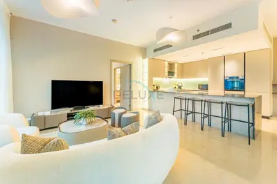 a living room with a white couch and a kitchen at Full Yacht Harbour and Marina Canal Views, Walking Distance to Tram Station and Beach - Shemara W2, Dubai Marina by Deluxe Holiday Homes in Dubai