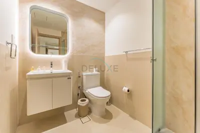 a bathroom with a toilet and a sink and a mirror at Full Yacht Harbour and Marina Canal Views, Walking Distance to Tram Station and Beach - Shemara W2, Dubai Marina by Deluxe Holiday Homes in Dubai