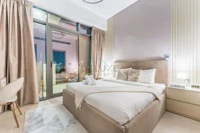 a bedroom with a large bed and a large window at Full Burj Khalifa and Dubai Canal views, Minutes from Downtown and Dubai Mall - Farhad Azizi Residence, Al Jaddaf by Deluxe Holiday Homes in Dubai