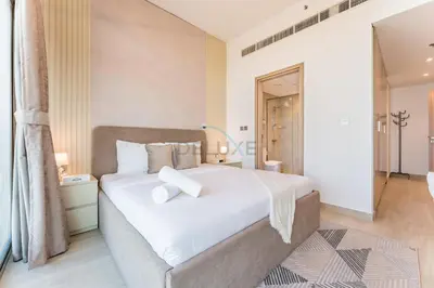 a bedroom with a large white bed in a room at Full Burj Khalifa and Dubai Canal views, Minutes from Downtown and Dubai Mall - Farhad Azizi Residence, Al Jaddaf by Deluxe Holiday Homes in Dubai