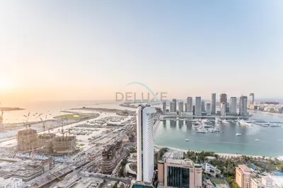 a view of the city of dubai from the sky at 3BR with Sea View, Short Stroll From Marina Walk and JBR Beach, With Easy Access to Tram and Metro - Ocean Heights, Dubai Marina by Deluxe Holiday Homes in Dubai