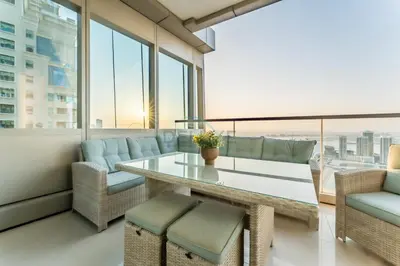 a dining room with a glass table and chairs at 3BR with Sea View, Short Stroll From Marina Walk and JBR Beach, With Easy Access to Tram and Metro - Ocean Heights, Dubai Marina by Deluxe Holiday Homes in Dubai
