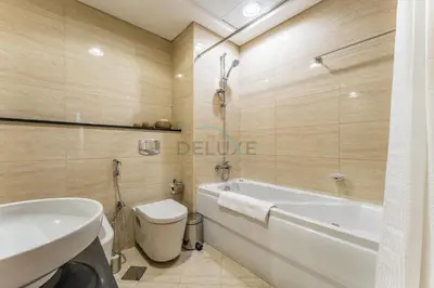 a bathroom with a tub and a toilet and a sink at 3BR with Sea View, Short Stroll From Marina Walk and JBR Beach, With Easy Access to Tram and Metro - Ocean Heights, Dubai Marina by Deluxe Holiday Homes in Dubai