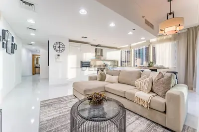 a living room with a couch and a table at 3BR with Sea View, Short Stroll From Marina Walk and JBR Beach, With Easy Access to Tram and Metro - Ocean Heights, Dubai Marina by Deluxe Holiday Homes in Dubai