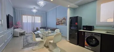 a living room with a table and chairs at Peaceful Apartments in Dubai