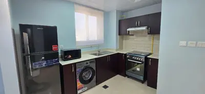a kitchen with a washing machine and a washer at Peaceful Apartments in Dubai