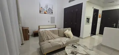 a living room with a couch and a table at Peaceful Apartments in Dubai