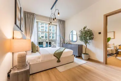 a bedroom with a bed and a large window at Walk from Burj Khalifa and Dubai Mall, and Conveniently Located near the Metro Station - BD Standpoint A, Downtown by Deluxe Holiday Homes in Dubai