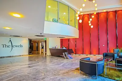 a lobby with a red wall in a building at The Jewel Tower 2 in Dubai