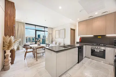 a kitchen and dining room with a view of the city at 833keys - 1BR - Waterfront Stay - Business Bay in Dubai
