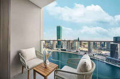 a balcony with two chairs and a table and a view at 833keys - 1BR - Waterfront Stay - Business Bay in Dubai