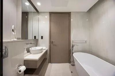 a bathroom with a tub and a sink and a bath tub at 833keys - 1BR - Waterfront Stay - Business Bay in Dubai