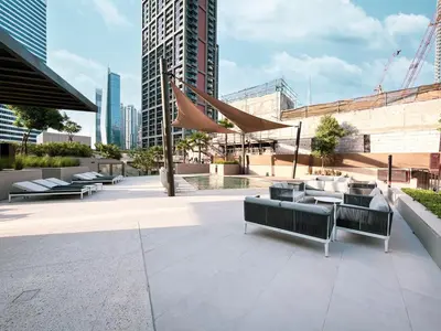 a patio with couches and tables in a city at 833keys - 1BR - Waterfront Stay - Business Bay in Dubai