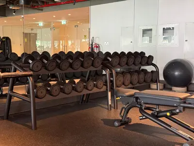 a gym with a bunch of dumbbells on a rack at Sterling West House in Dubai