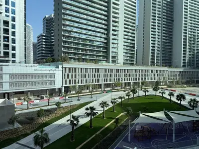 an overhead view of a building in a city with palm trees at Sterling West House in Dubai